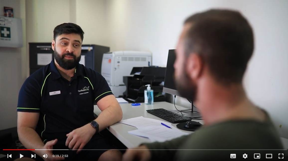 video screenshot of two men talking