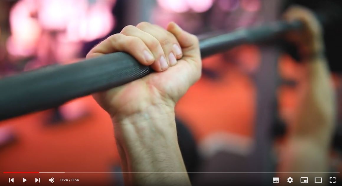 Video still of hands gripping a barbell