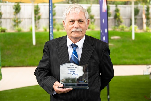 Colin holding up Citizen of the Year Award