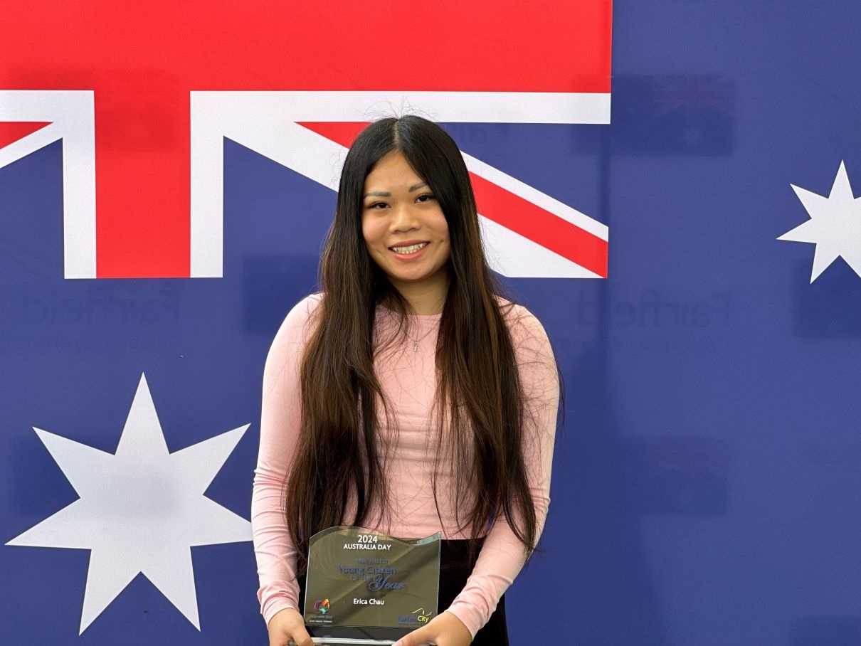 The portrait of Erica Chau holding up the Young Citizen of the Year Award