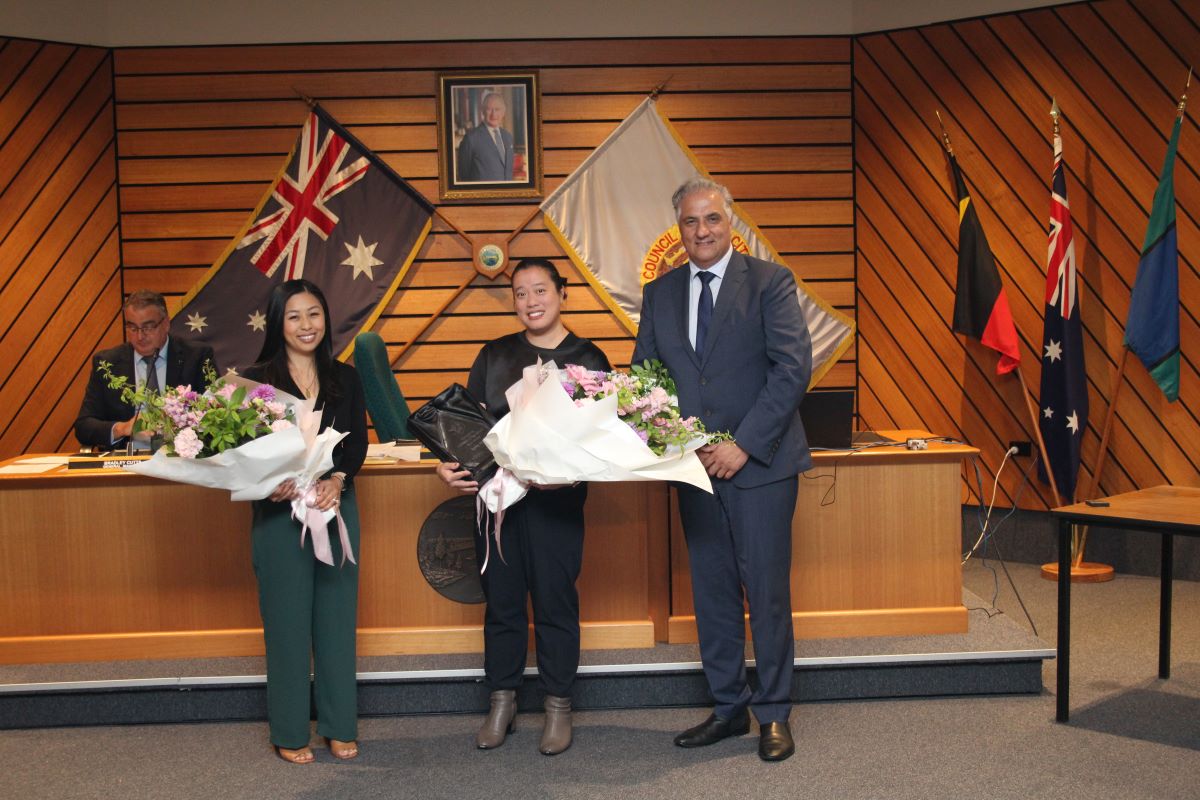 Posing Sally Hsu holding the Women's Day Award with the mayor and the last year Women's Day Award Kim Tran.