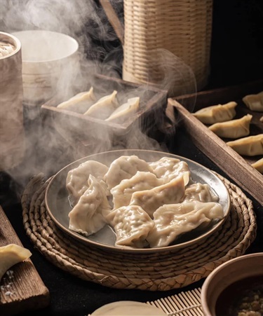 Steam rising from fresh dumplings