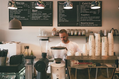 hospitality worker making coffee