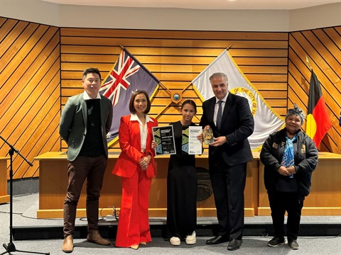 mayor and councillors with a youth award recipient in the council chambers