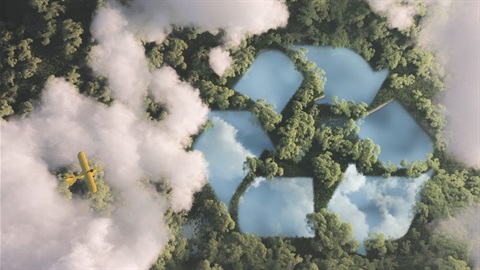 Aerial view of rainforest waterways in the shape of the recycling logo
