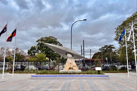 Monument flanked by flags at The Crescent