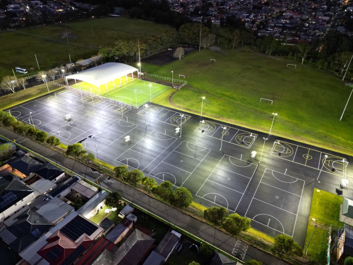 Night time aerial photo of Endeavour Sports Park multipurpose courts.
