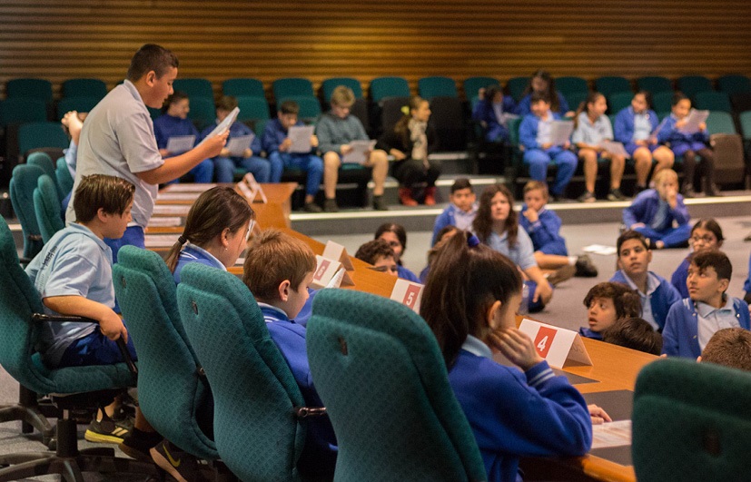 Children in Council chambers conducting a mock Council meeting