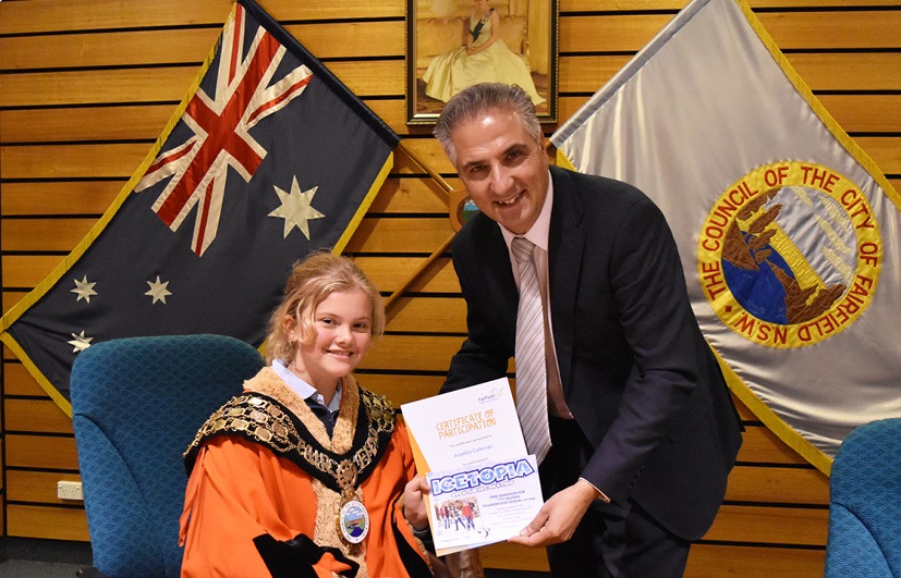 Young student Council robes receiving certificate from Mayor Frank Carbone