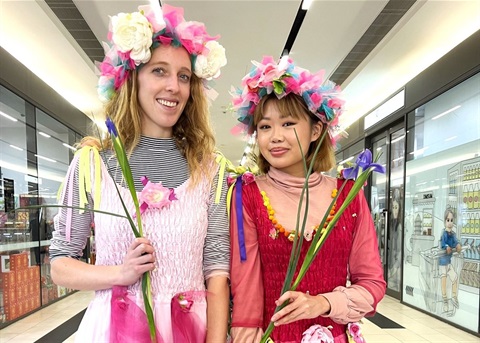 Girls dressed up as fairies with flowers. 
