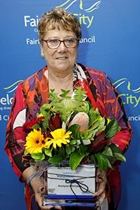 Krystyna Whittaker holding up Volunteer of the Year Award