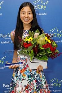 Rowena Tran holding up Young Citizen of the Year Award