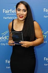 Simaima Taufa holding up Sports Achiever of the Year Award