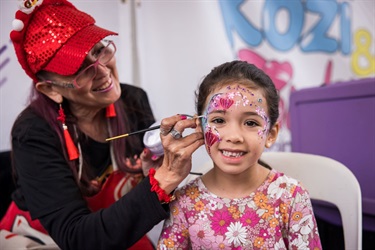 A smiling kid in new year face painting
