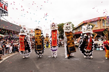 Dancing lions walking and hold new year wishing banner
