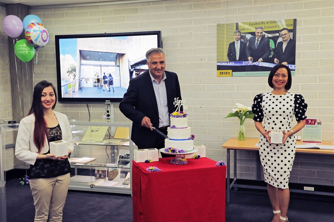 Fairfield City Mayor Frank Carbone cuts the library cake with Councillors Sera Yilmaz and Dai Le