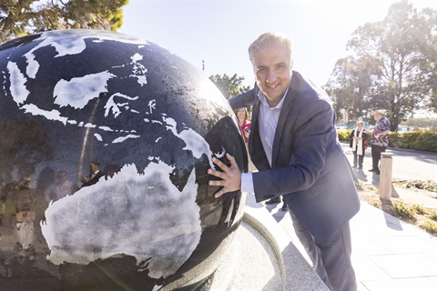 Mayor Carbone posing next to the brand new People's Globe kugel ball