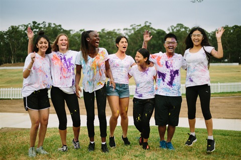 Fairfield Youth Advisory Committee members smiling and posing while covered in paint 