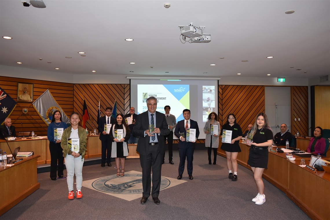 Mayor Frank Carbone smiling and posing with Mayor's Youth Achievement Award winners