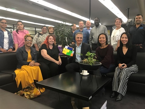 Mayor Frank Carbone and Councillor Dai Le smiling and posing with local business people in the Workary at Whitlam Library