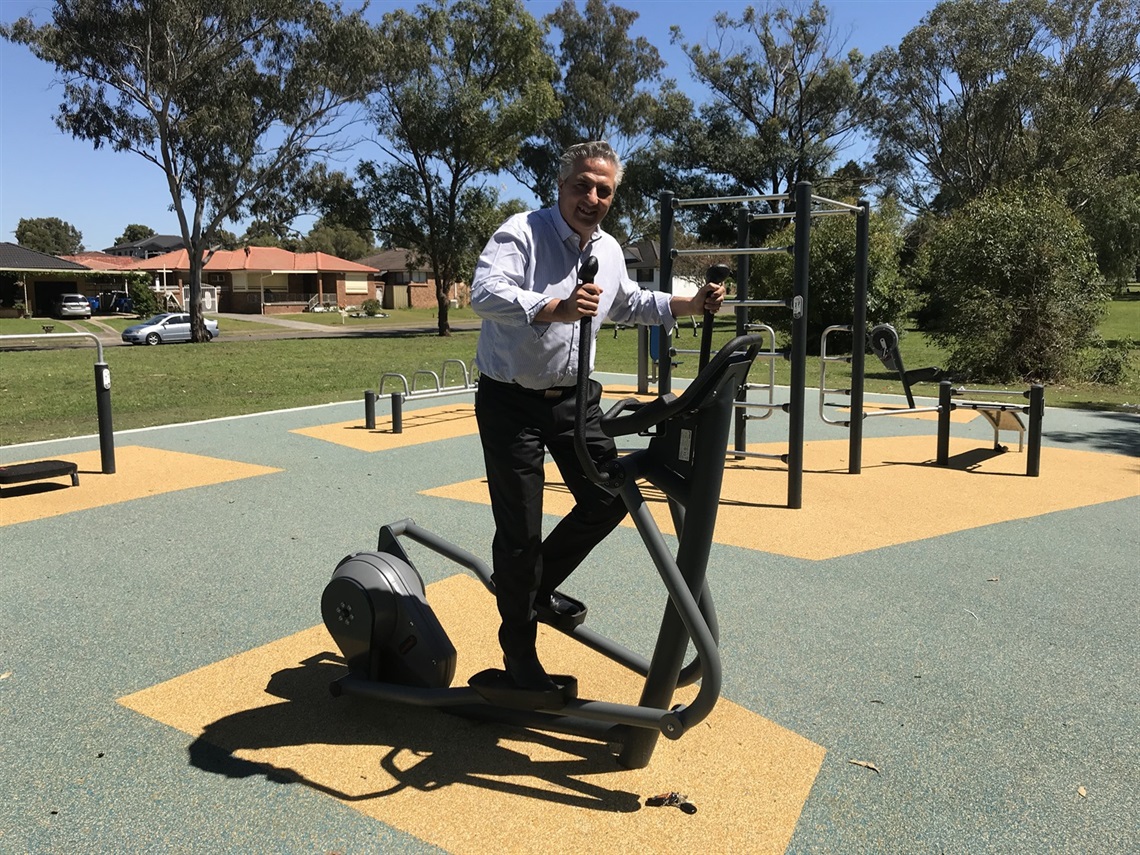Mayor Carbone using outdoor gym equipment at Chisholm Park