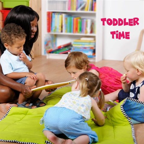 Image of female carer reading a book to four toddlers text reads toddler time