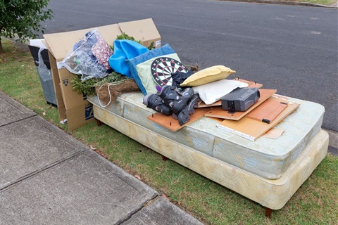 Large household waste items sitting on road side waiting for kerb side clean up.