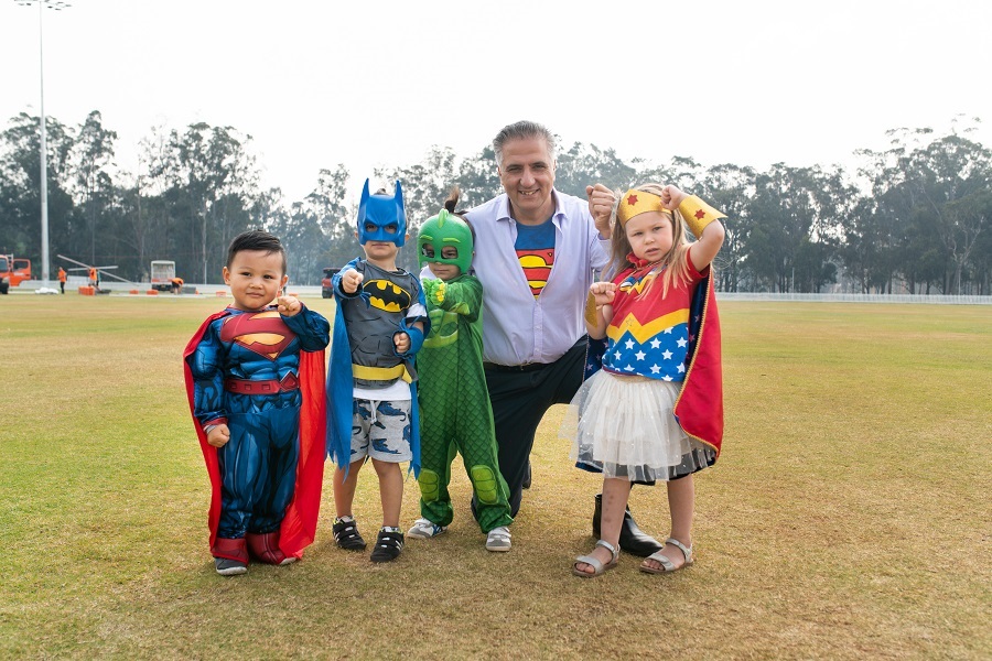 Mayor Frank Carbone with children dressed as superheroes