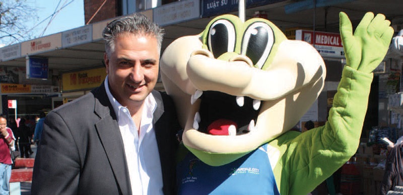 Mayor Frank Carbone smiling and posing with Fairfield City Leisure Centre mascot, Active Gator 