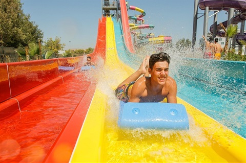 Young boys sliding down the 3 Lane Racing Ride 