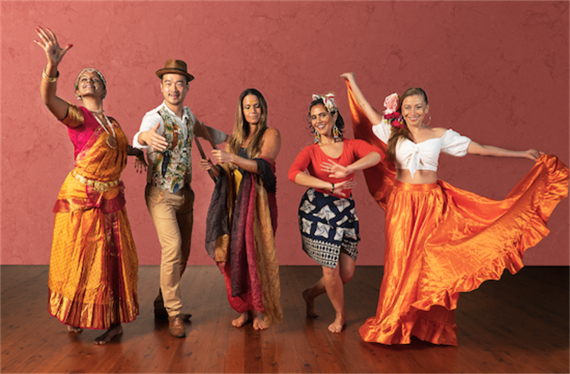 Group of people posing in different cultural dance costumes 