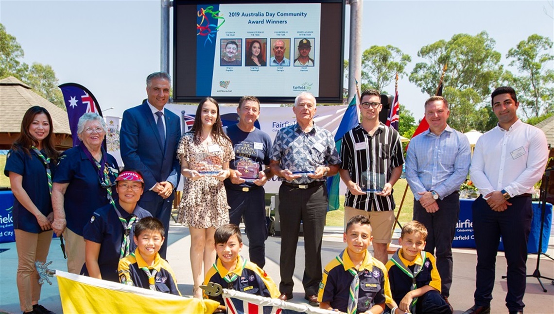 Mayor Frank Carbone and Hon. Chris Bowen MP smiling and posing with 2019 Australia Day Awards winners