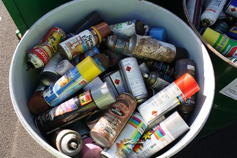 Tub of empty aerosol cans 