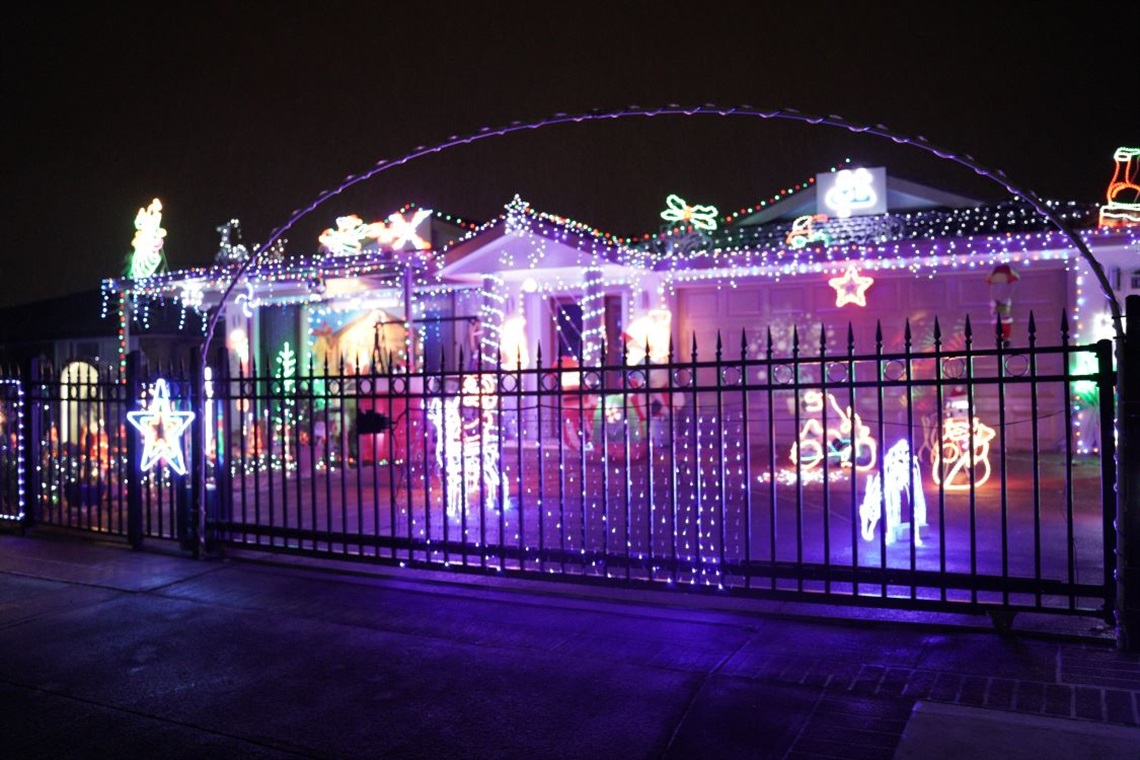 A house brightly lit with Christmas LED lights and decorations in the night 