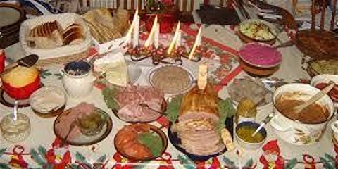 Variety of home cooked dishes sitting on a Christmas themed table cloth 