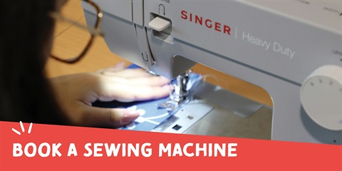 A person is using a Singer Heavy Duty sewing machine.