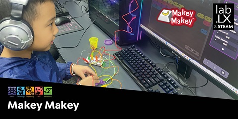Kid playing Electrical Circuits: Makey Makey.