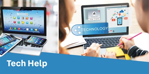 A student receiving tech support from a tutor, surrounded by laptops and educational materials in a bright classroom setting.
